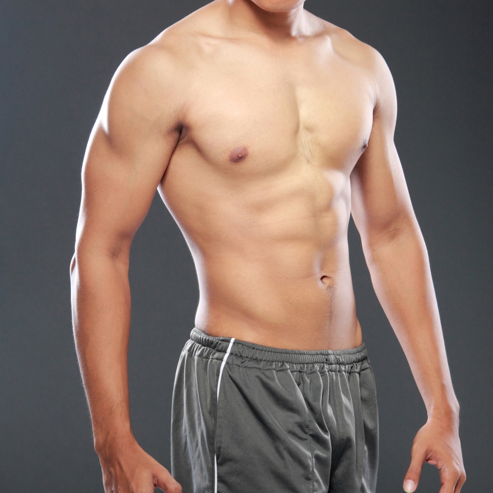 a young and fit male model posing his muscles